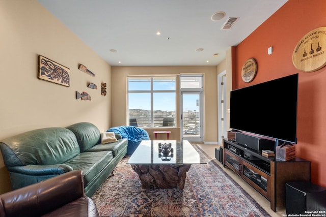 living area featuring light carpet, recessed lighting, visible vents, and baseboards