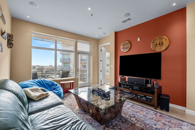 living area featuring recessed lighting, tile patterned flooring, visible vents, and baseboards