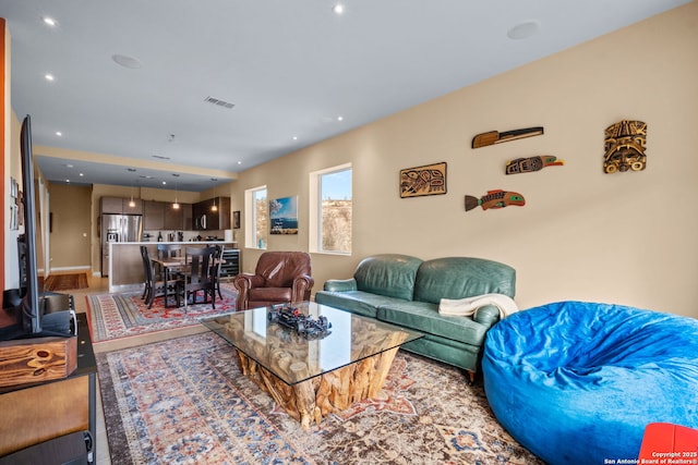 living area with visible vents and recessed lighting