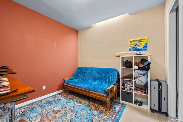 bedroom with baseboards and light tile patterned flooring