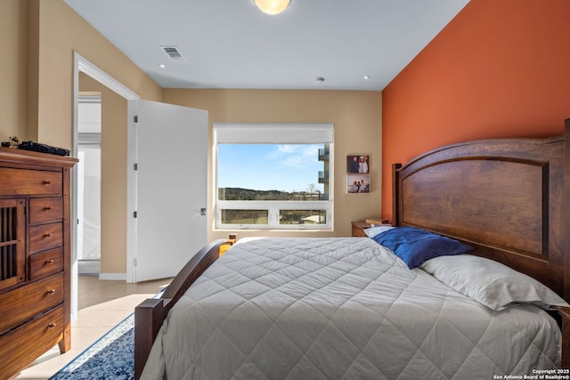 bedroom featuring light tile patterned floors and visible vents