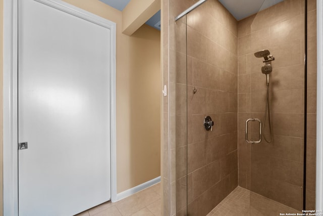 full bathroom featuring tile patterned flooring, a shower stall, and baseboards