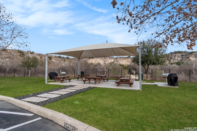 surrounding community featuring a lawn and fence