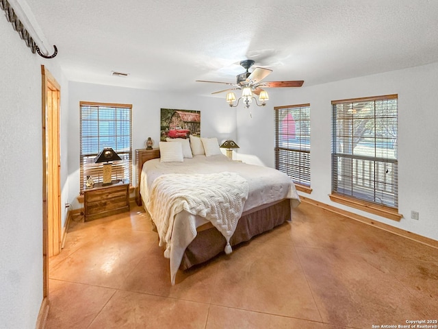 bedroom featuring a textured ceiling, ceiling fan, light tile patterned floors, and visible vents