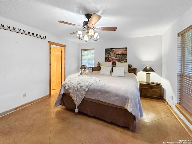 bedroom with baseboards and a ceiling fan