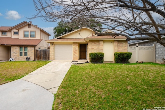 view of front facade with driveway, fence, and a front lawn