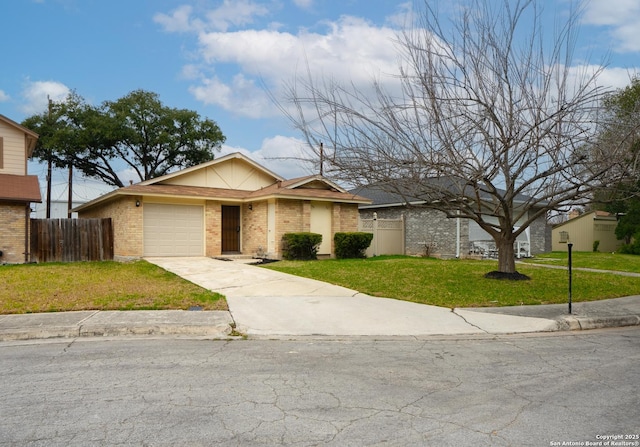 view of front of house with a garage, a front yard, brick siding, and fence