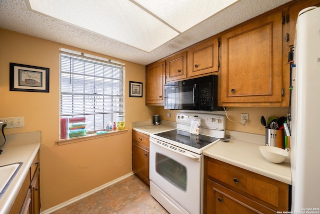 kitchen featuring brown cabinets, white appliances, light countertops, and a textured ceiling