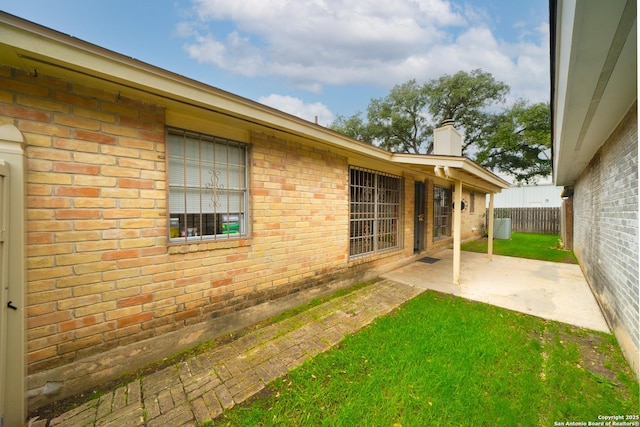 view of yard with fence and a patio