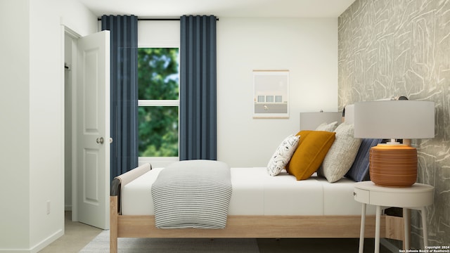 carpeted bedroom featuring an accent wall and wallpapered walls