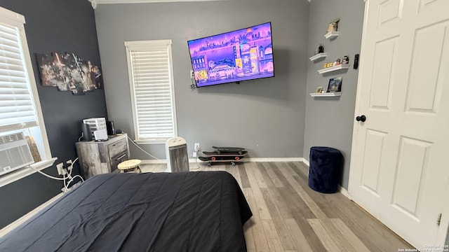 bedroom with light wood-type flooring and baseboards