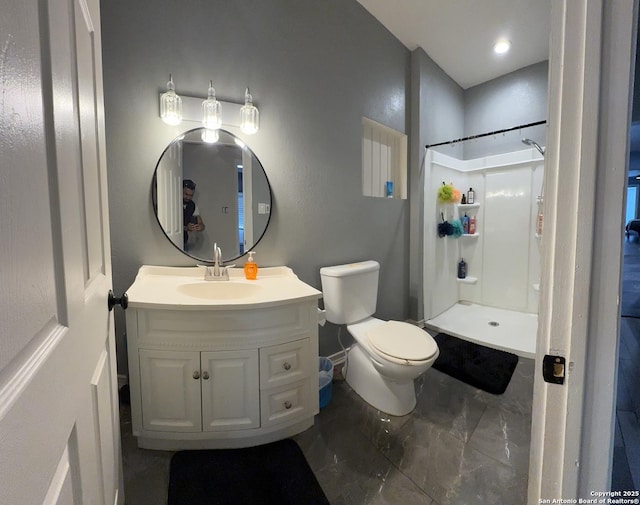 bathroom with toilet, a stall shower, and vanity