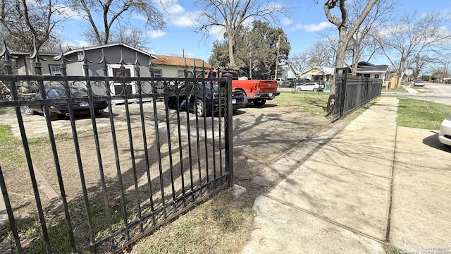 view of gate featuring a residential view and fence