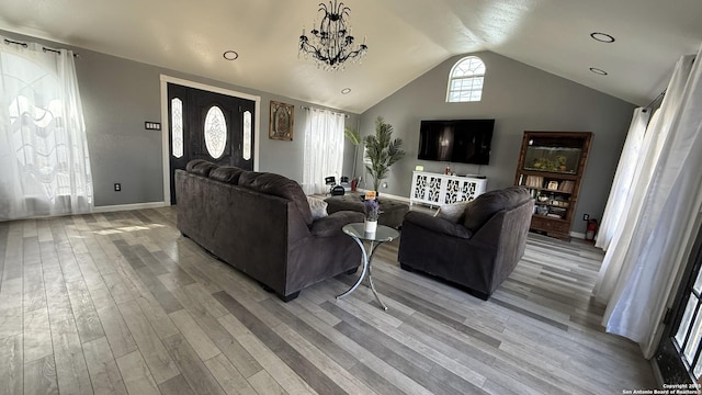 living area featuring light wood-style floors, lofted ceiling, and baseboards