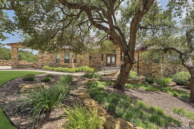 view of front of property with stone siding and french doors