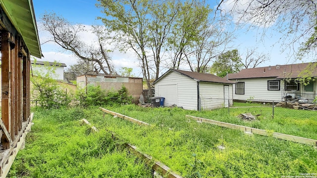 view of yard with fence and an outdoor structure