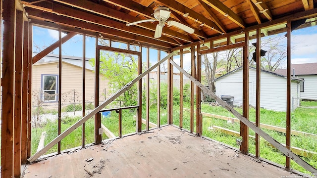 unfurnished sunroom with ceiling fan