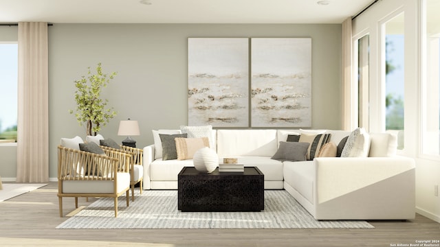 living area featuring light wood-style flooring and baseboards