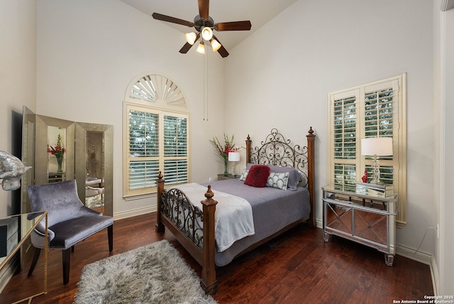 bedroom featuring baseboards, high vaulted ceiling, ceiling fan, and dark wood-type flooring