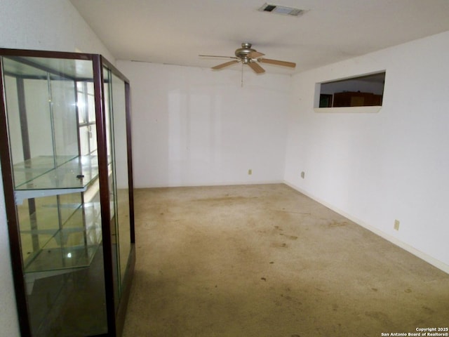 empty room with light carpet, ceiling fan, and visible vents