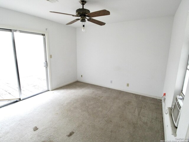 spare room featuring a ceiling fan, carpet, visible vents, and baseboards