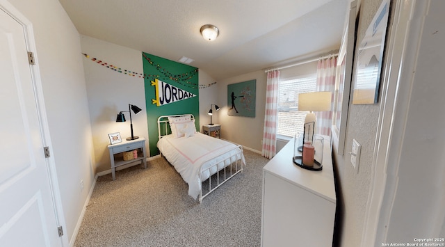 carpeted bedroom featuring baseboards