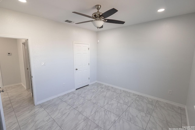 empty room with marble finish floor, recessed lighting, visible vents, a ceiling fan, and baseboards