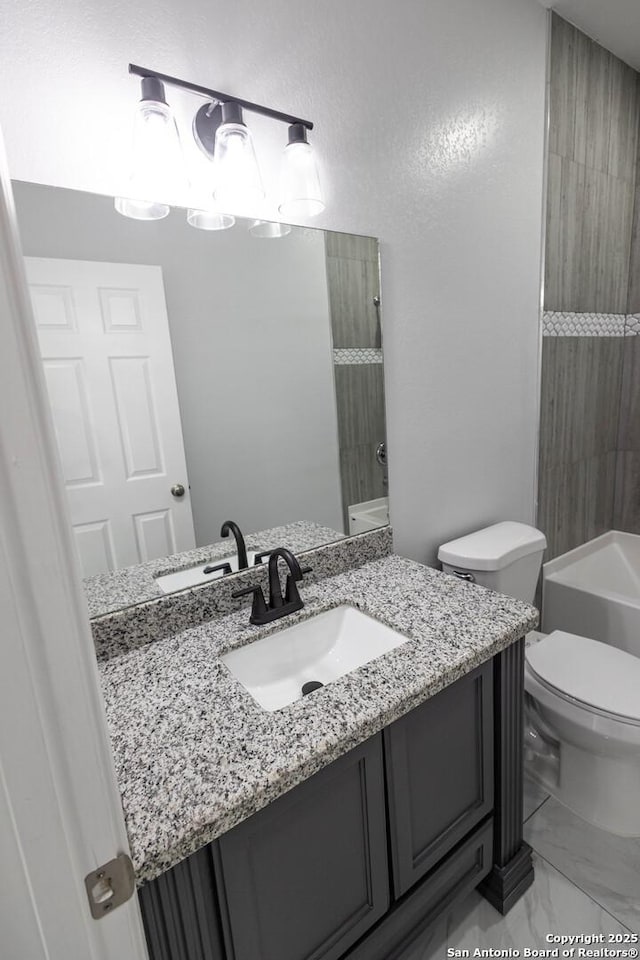 bathroom with marble finish floor, shower / bath combination, vanity, and toilet