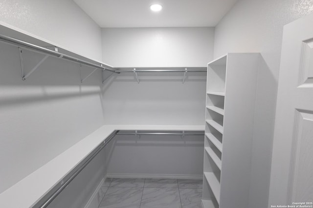 spacious closet with marble finish floor