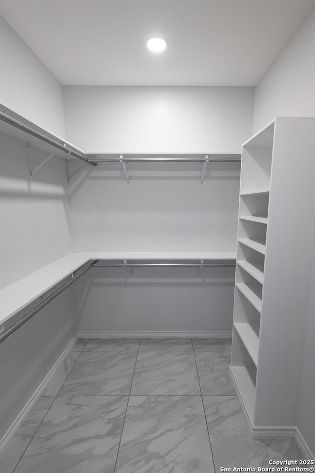 spacious closet with marble finish floor