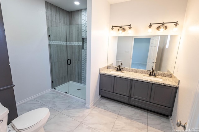 bathroom with marble finish floor, a shower stall, baseboards, and a sink