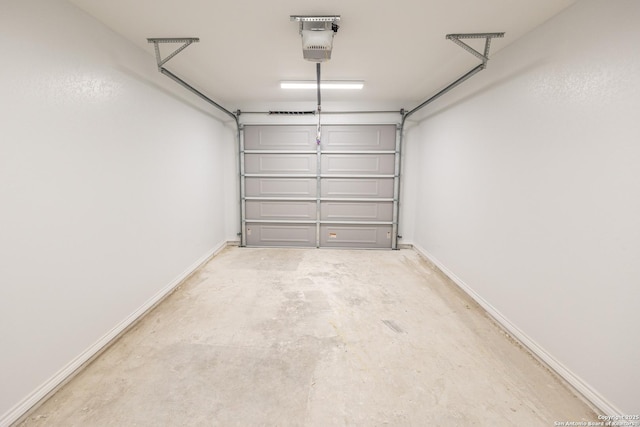 garage with baseboards and a garage door opener