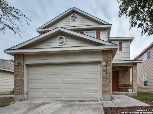 view of front of home featuring driveway, brick siding, and an attached garage