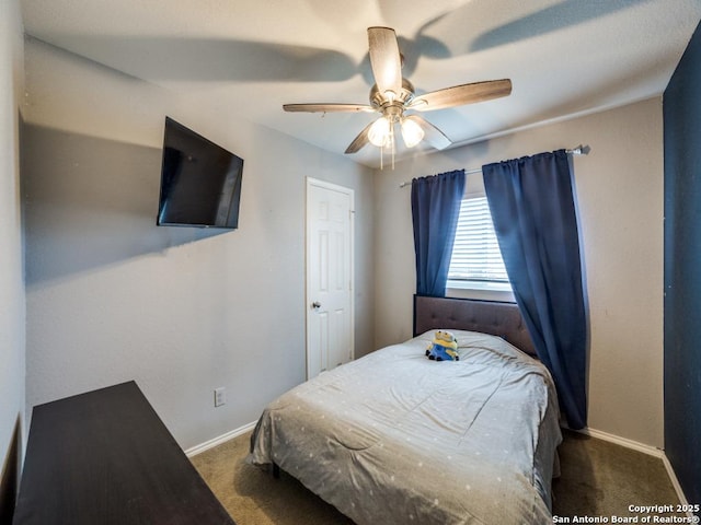 bedroom with baseboards, dark colored carpet, and a ceiling fan