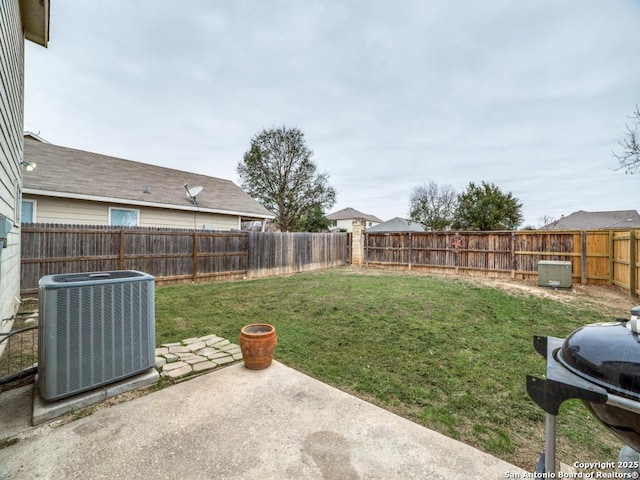 view of yard featuring a patio area, a fenced backyard, and central air condition unit