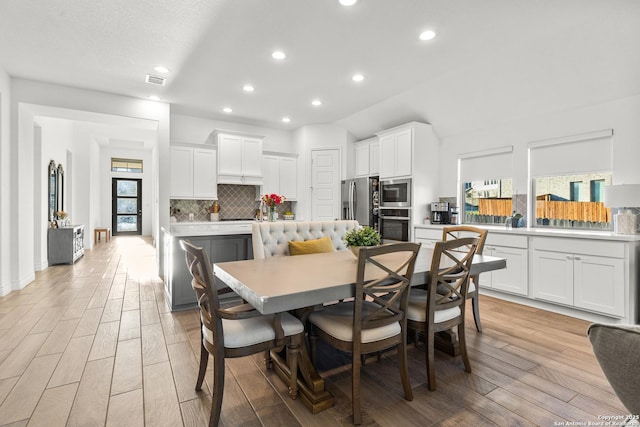 dining area featuring light wood-type flooring, visible vents, and recessed lighting