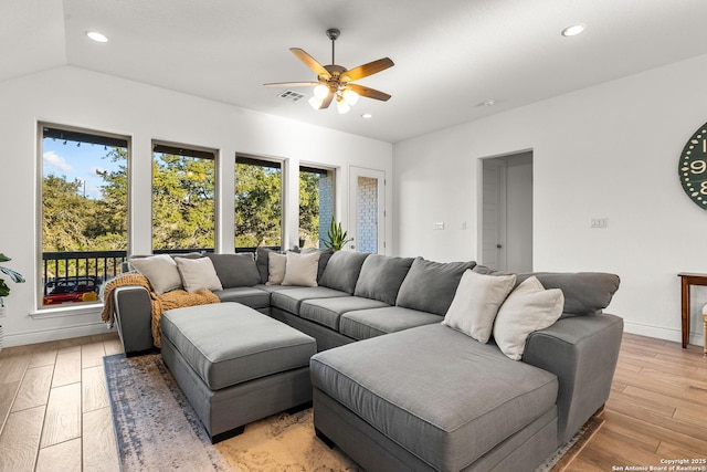 living room featuring light wood-type flooring, baseboards, visible vents, and recessed lighting