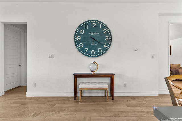 interior space with baseboards and light wood finished floors