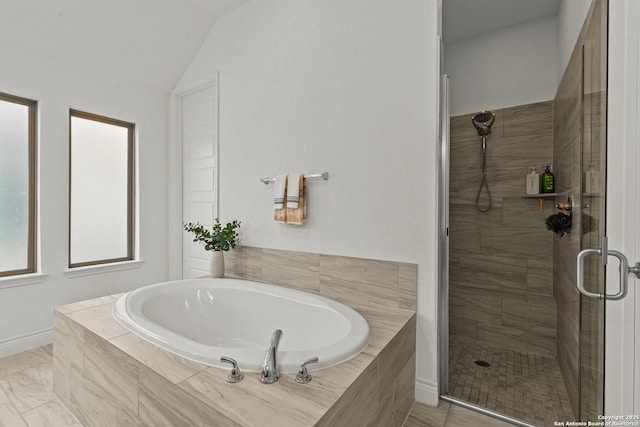 full bathroom with lofted ceiling, a garden tub, and a stall shower