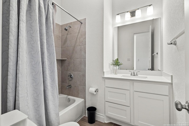 full bathroom with wood finished floors, vanity, and shower / bath combo with shower curtain