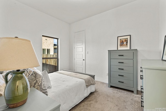 bedroom featuring light carpet and baseboards