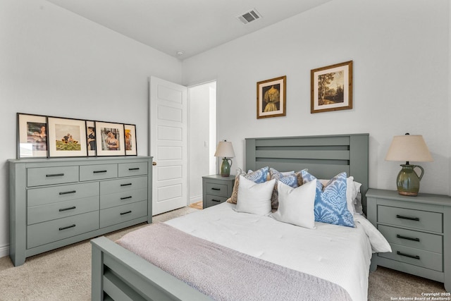 bedroom with visible vents and light colored carpet