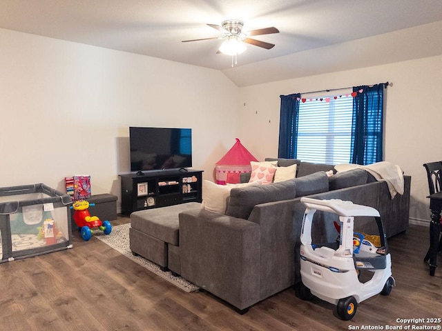 living area featuring vaulted ceiling, ceiling fan, and wood finished floors