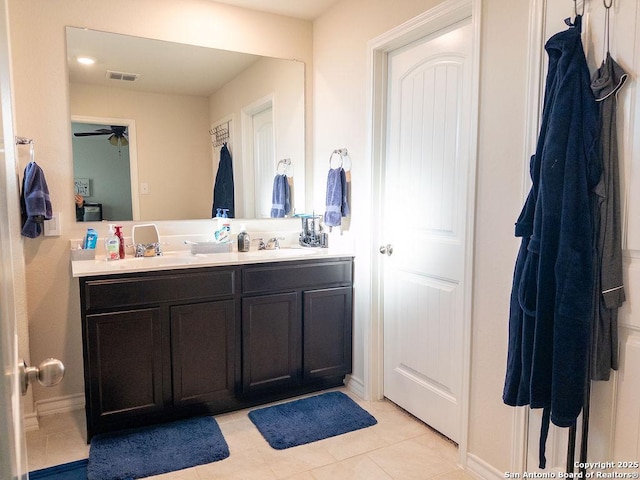 bathroom with double vanity, ceiling fan, visible vents, and a sink