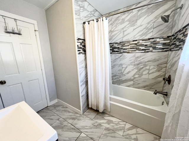 full bath with marble finish floor, shower / bath combo, and baseboards