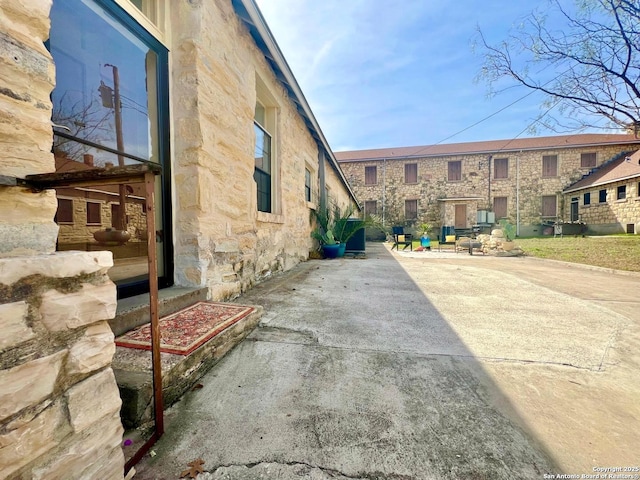 view of side of home with a patio area