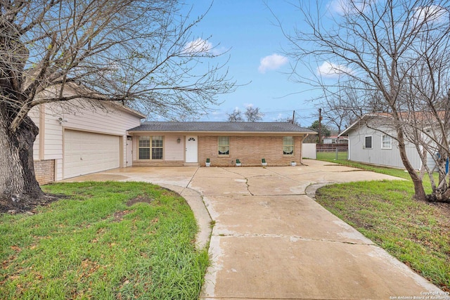 ranch-style house with brick siding, an attached garage, a front lawn, fence, and driveway