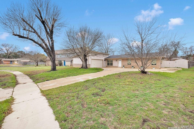 ranch-style home featuring fence, driveway, a front lawn, a garage, and brick siding