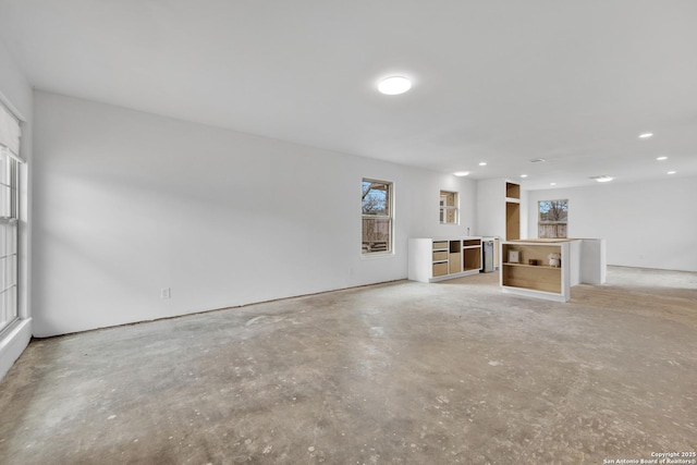 unfurnished living room with concrete floors