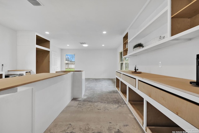 bar featuring concrete flooring, visible vents, and recessed lighting